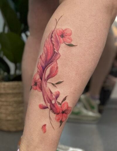 Watercolor fish tattoo with flowers on leg, colorful koi style tattoo Porto