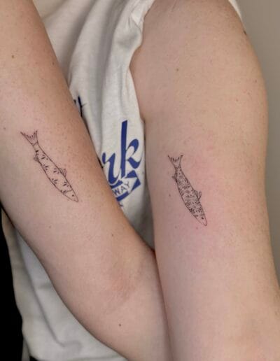minimalist azulejo sardine tattoo on arm fine line Portuguese tile pattern Porto