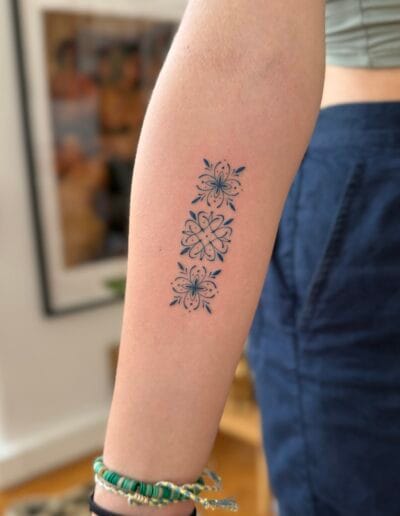 Small azulejo tattoos on forearm, fine line Portuguese tile pattern tattoos in Porto