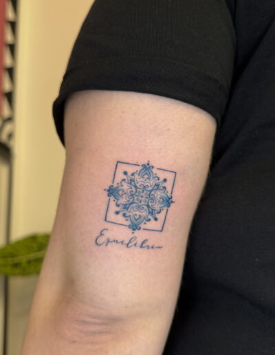 Blue azulejo tattoo on inner arm with script lettering, Portuguese tile tattoo in Porto