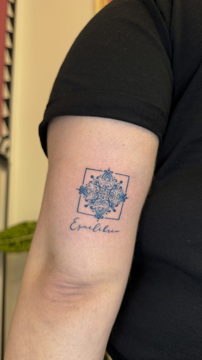 Blue azulejo tattoo on inner arm with script lettering, Portuguese tile tattoo in Porto