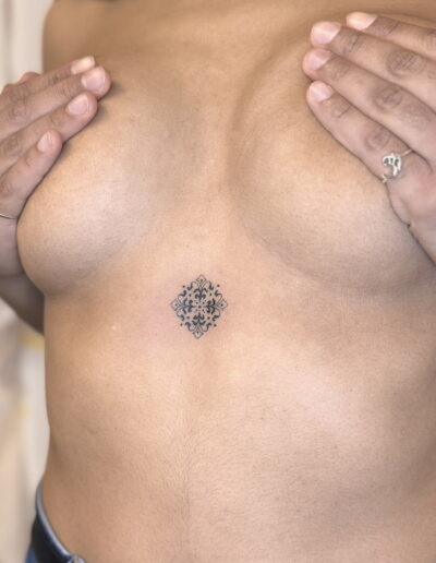Small azulejo tattoo on chest, fine line Portuguese tile pattern tattoo Porto