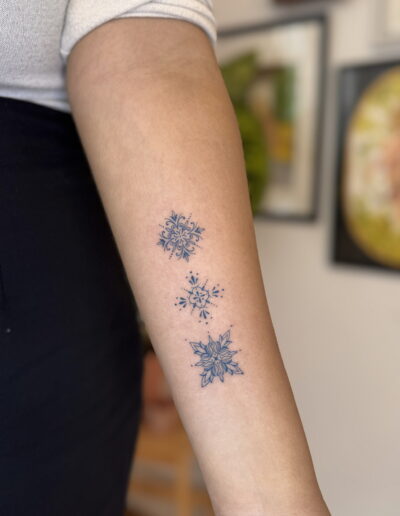 Small azulejo tile tattoos on forearm, Portuguese ceramic pattern fine line tattoo Porto
