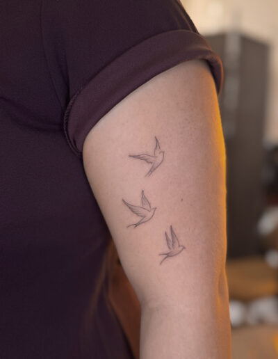Fine line flying birds tattoo on upper arm, minimalist bird tattoo Porto