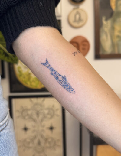 Fine line sardine tattoo on inner forearm with azulejo tile pattern, Portuguese tattoo Porto