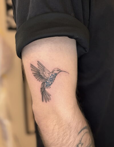 Fine line hummingbird tattoo with azulejo pattern on upper arm, Porto tattoo