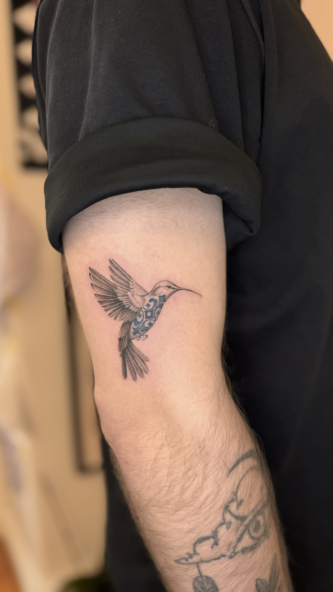Fine line hummingbird tattoo with azulejo pattern on upper arm, Porto tattoo