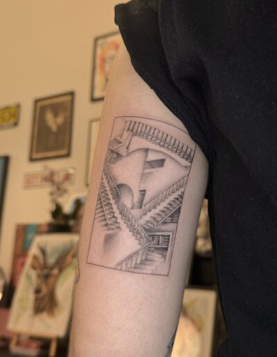 Fine line optical illusion stairs tattoo on upper arm, geometric impossible architecture tattoo Porto