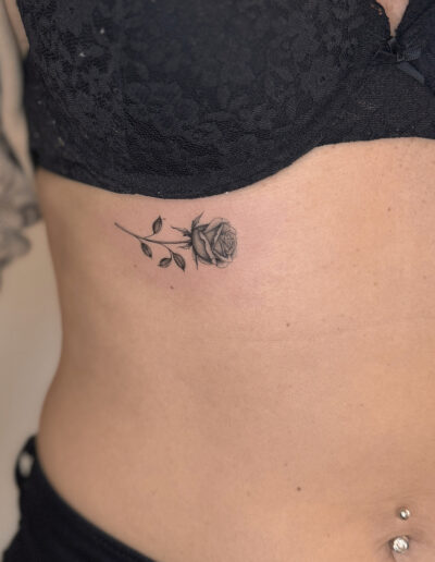 Small fine line rose tattoo on rib cage, delicate minimalist flower tattoo Porto