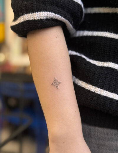 Small minimalist azulejo tattoo on inner forearm, fine line Portuguese tile tattoo in Porto