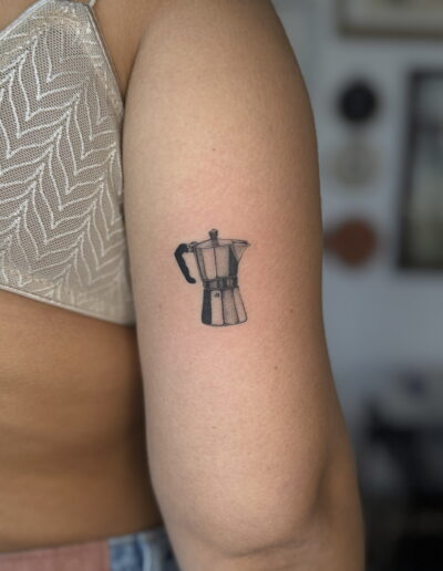 Minimalist coffee maker tattoo on outer arm, small fine line coffee tattoo Porto