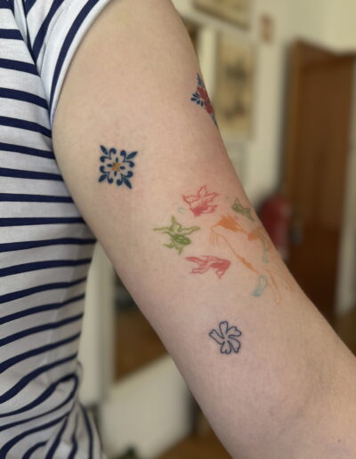 Small blue azulejo tile tattoo on arm in Porto Portugal by KORKACH Kateryna, fine line ornamental design