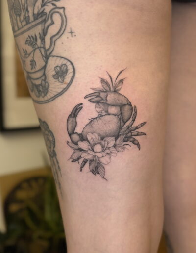 Crab tattoo with flowers in black and grey on arm in Porto Portugal by KORKACH Kateryna