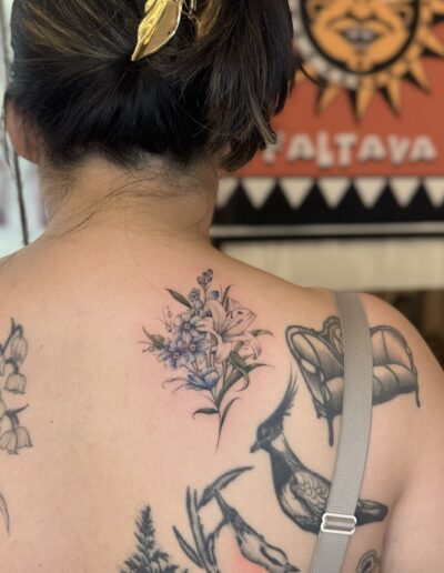 Fine line floral tattoo on shoulder in Porto Portugal by KORKACH Kateryna, delicate botanical design