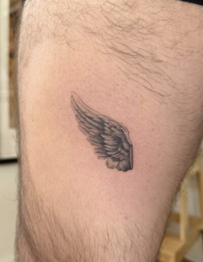 Small realistic wing tattoo on chest in Porto Portugal by KORKACH Kateryna