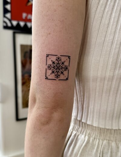 Fine line azulejo tile tattoo on arm in Porto Portugal by KORKACH Kateryna, symmetrical ornamental design