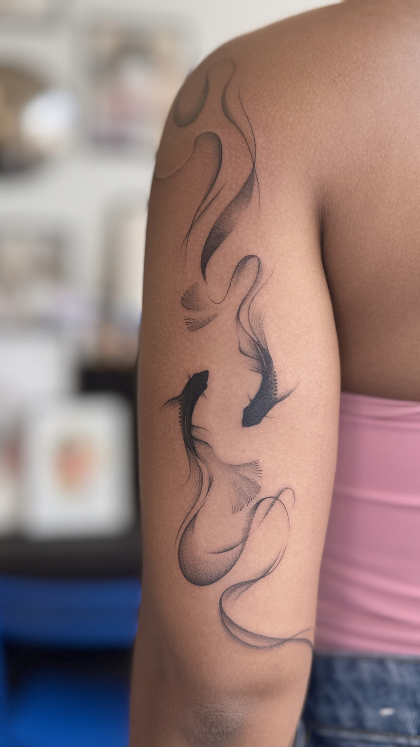 Fine line koi fish tattoo with flowing lines on arm in Porto Portugal by KORKACH Kateryna