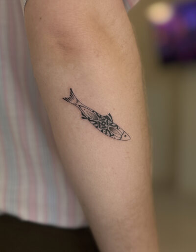 Sardine tattoo with bold azulejo pattern fine line on arm in Porto Portugal by KORKACH Kateryna