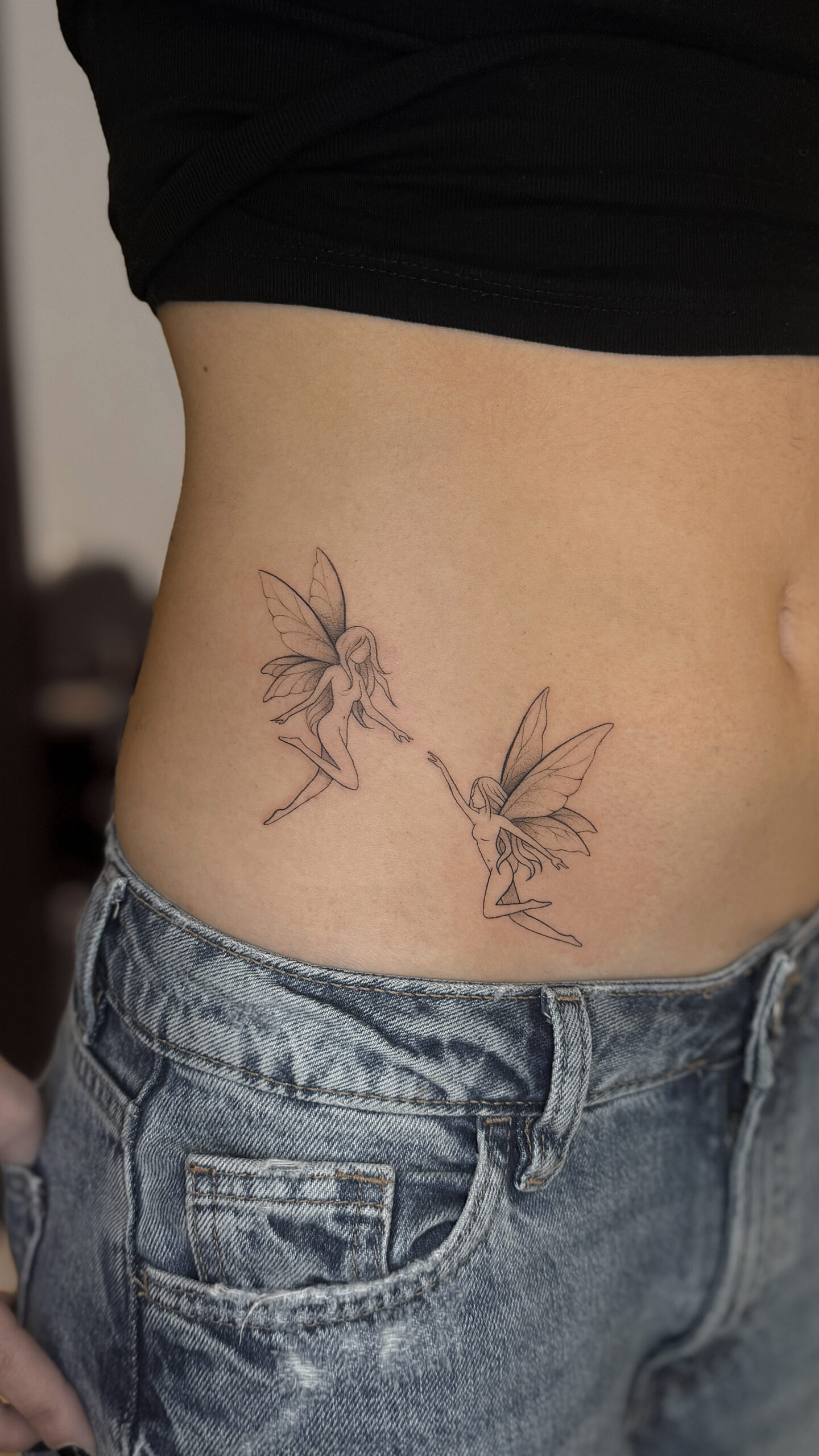 Fine line fairy tattoo on side torso delicate fantasy tattoo by KORKACH Kateryna Porto Portugal